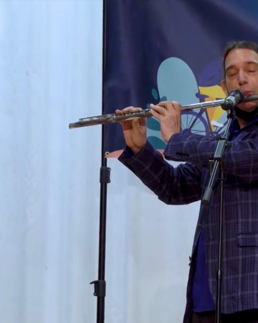 Dan on flute, eyes closed, at the Crack the Wellness Code gathering